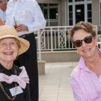 Woman in a sunhat smiling with another guest at Naples 2019